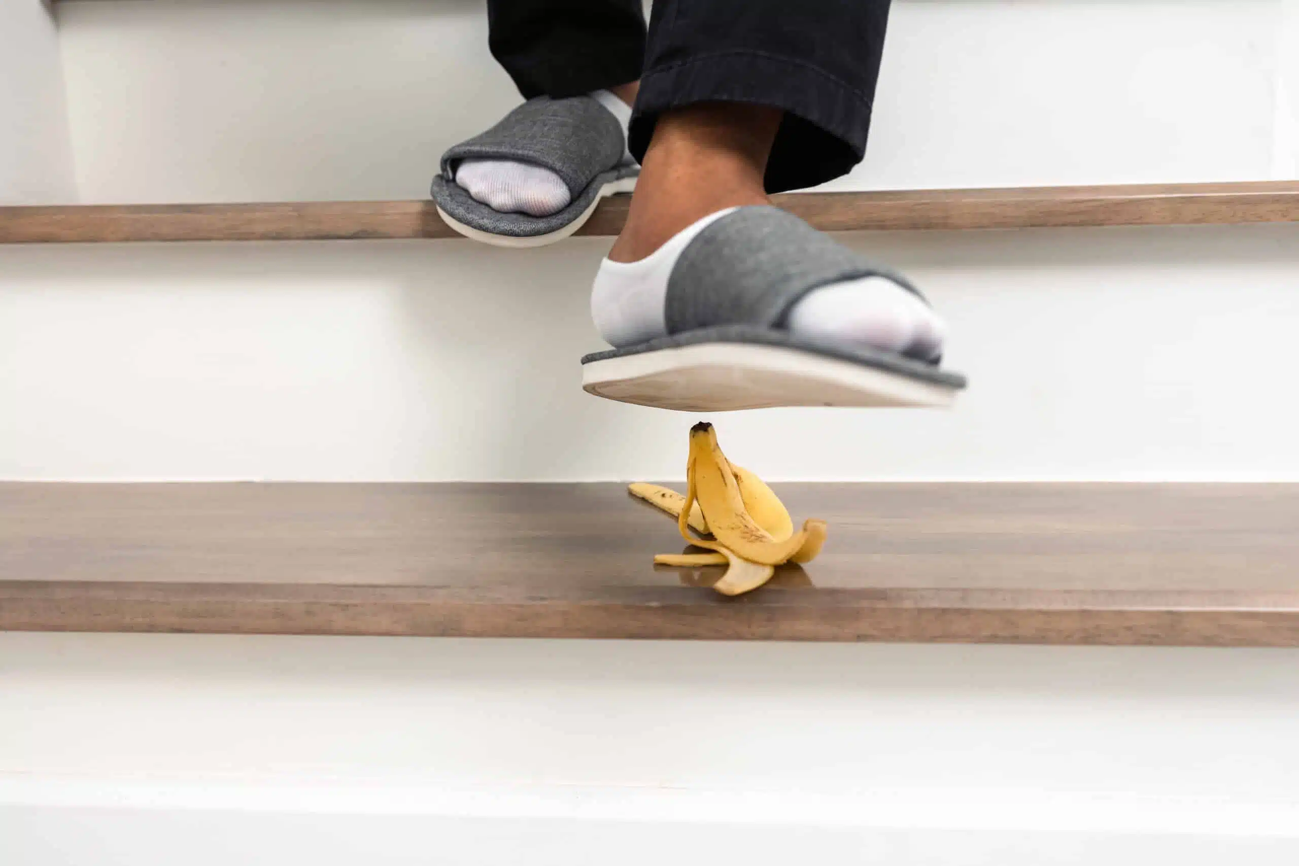 banana peel on slippery stair and foor standing on it causing a slip and fall injury